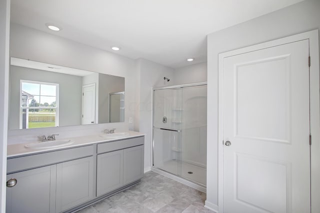 bathroom with vanity and a shower with shower door