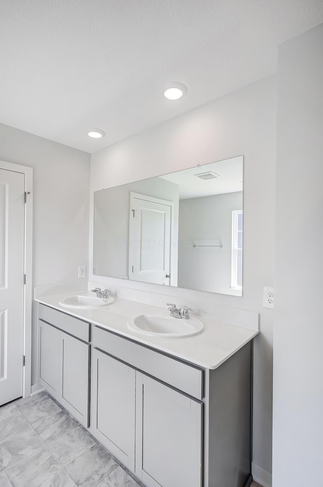 bathroom featuring vanity and a textured ceiling