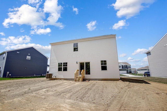 rear view of property with central AC