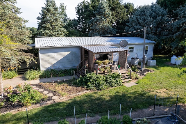 view of front of property with a wooden deck and a front lawn