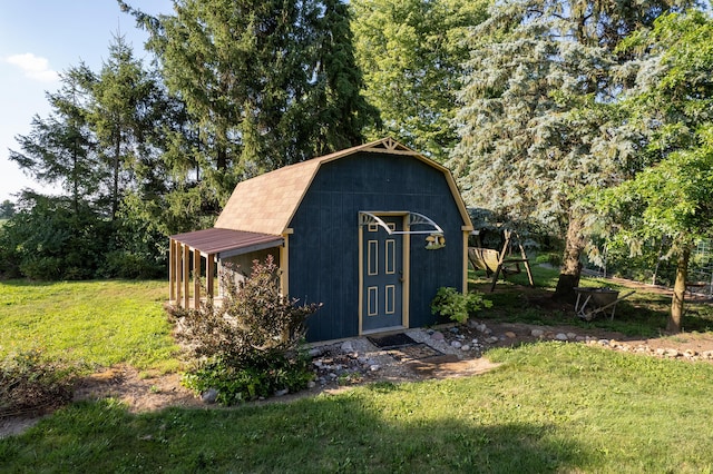 view of outbuilding featuring a lawn