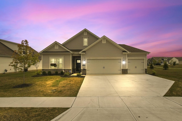 craftsman house with a garage and a yard