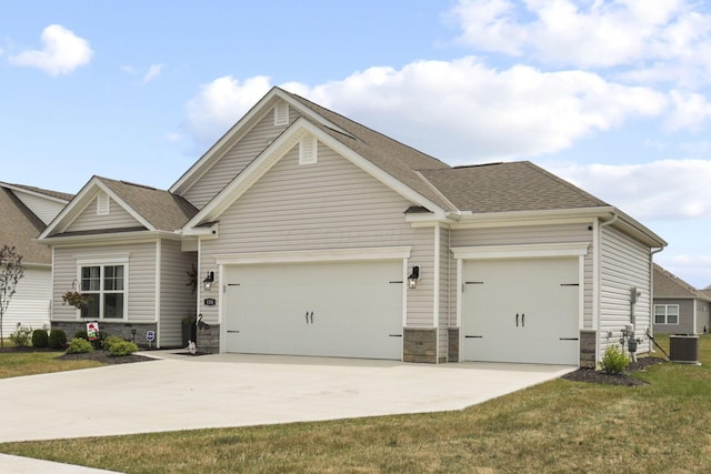 craftsman-style house featuring a garage, a front yard, and central AC