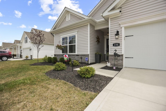 entrance to property featuring a garage and a lawn