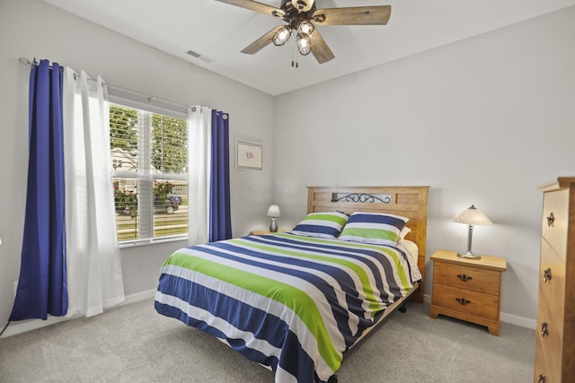 bedroom with ceiling fan and light carpet