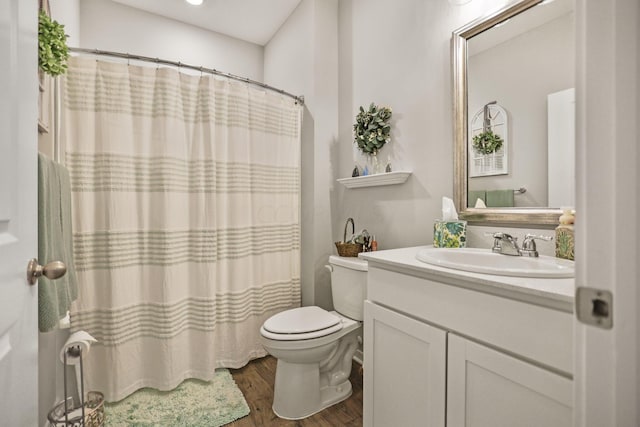 bathroom with hardwood / wood-style flooring, vanity, and toilet