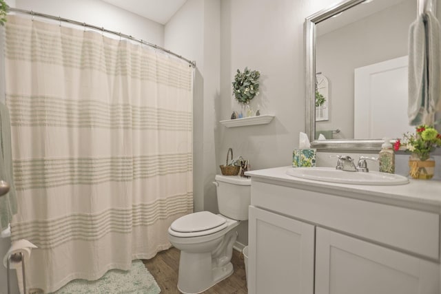 bathroom featuring hardwood / wood-style flooring, vanity, and toilet