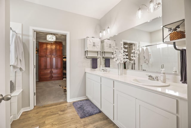 bathroom featuring walk in shower, vanity, and hardwood / wood-style flooring