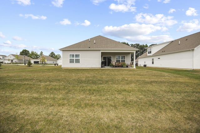 back of property featuring a yard and a patio