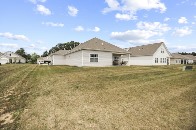 rear view of property with a lawn