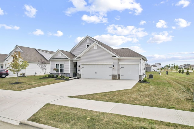 view of front of house with cooling unit, a garage, and a front yard