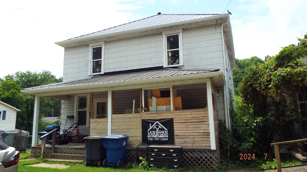 rear view of property with a porch