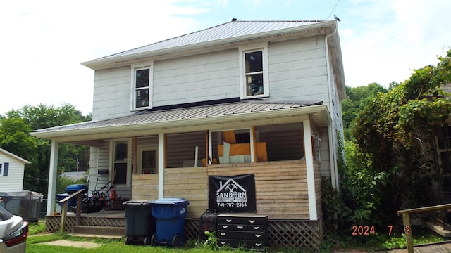 rear view of property with a porch