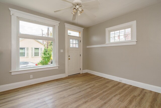 entryway with light hardwood / wood-style flooring, a wealth of natural light, and ceiling fan