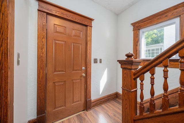 foyer with light hardwood / wood-style floors and a textured ceiling