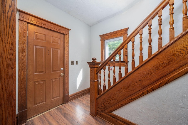 foyer with hardwood / wood-style floors and a textured ceiling