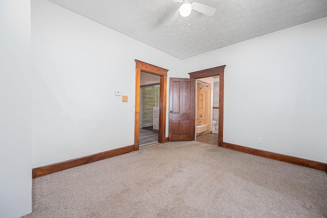 empty room featuring carpet, a textured ceiling, and ceiling fan