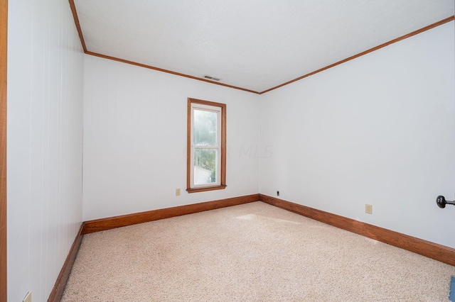 spare room with carpet floors and crown molding