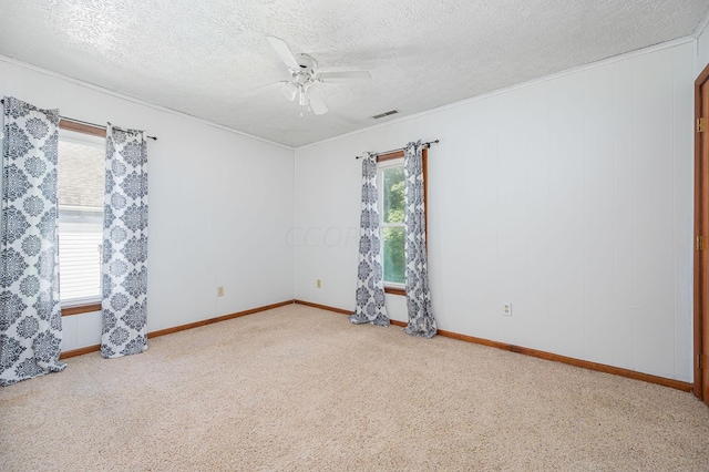 spare room featuring carpet, a textured ceiling, and ceiling fan