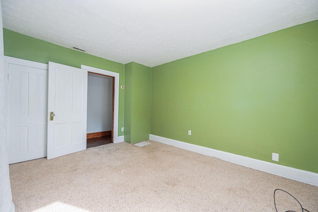 unfurnished bedroom with carpet floors and a closet