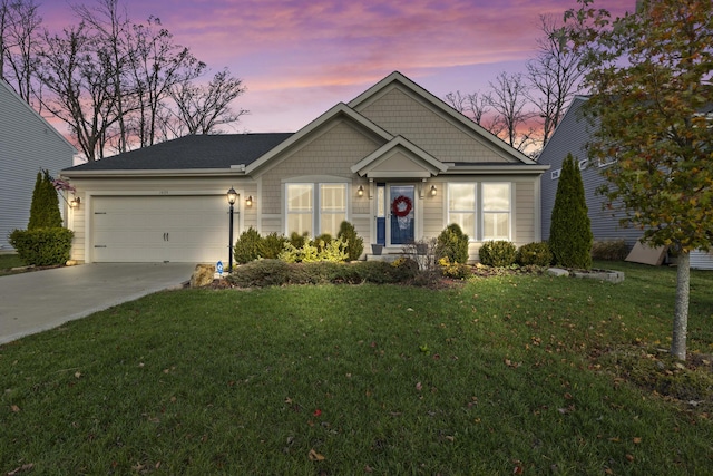 view of front of house with a lawn and a garage