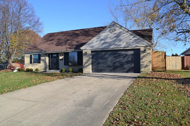 ranch-style house with a garage and a front lawn