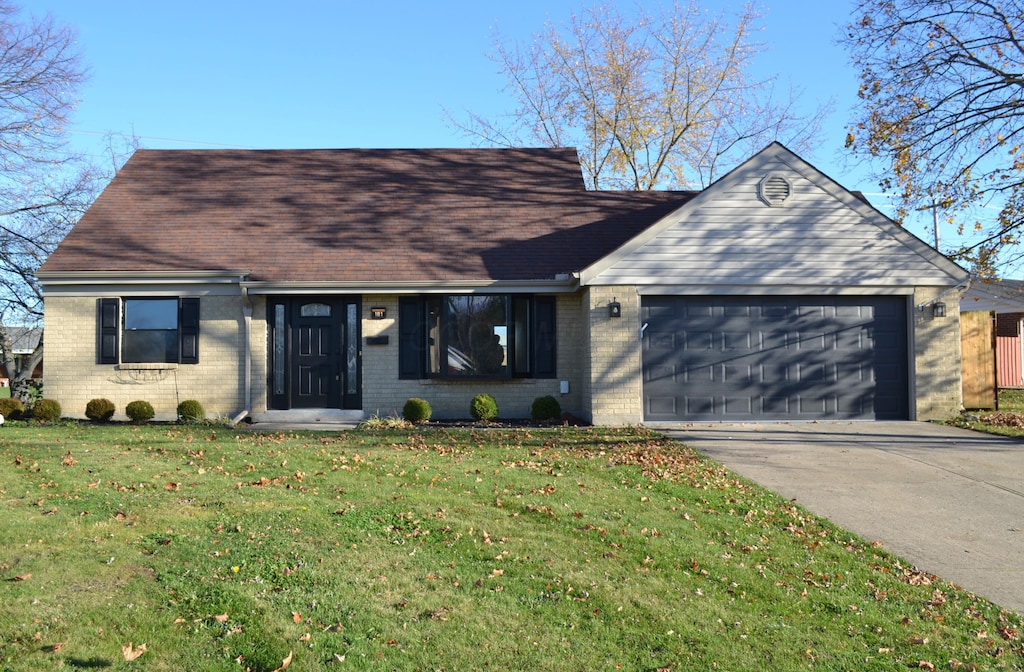 view of front of property with a garage and a front yard