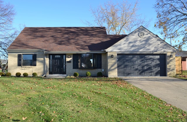 view of front of property with a garage and a front yard