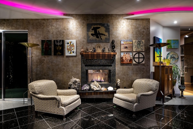 living area with a tile fireplace