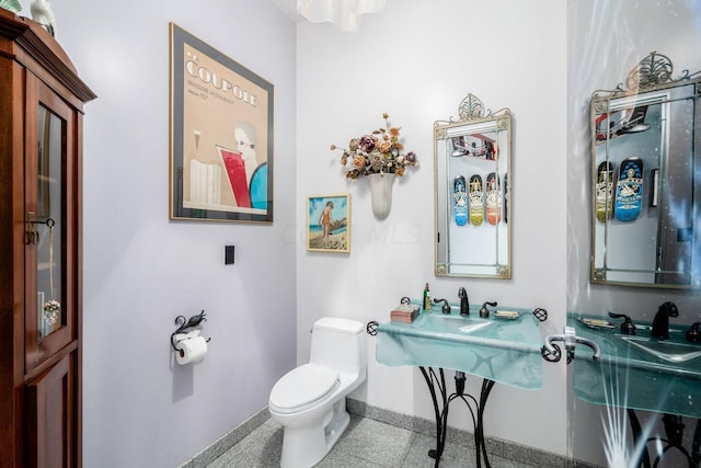 bathroom featuring sink, tile patterned flooring, and toilet