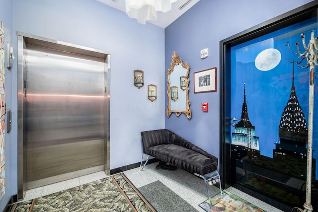 entryway featuring light tile patterned floors and elevator