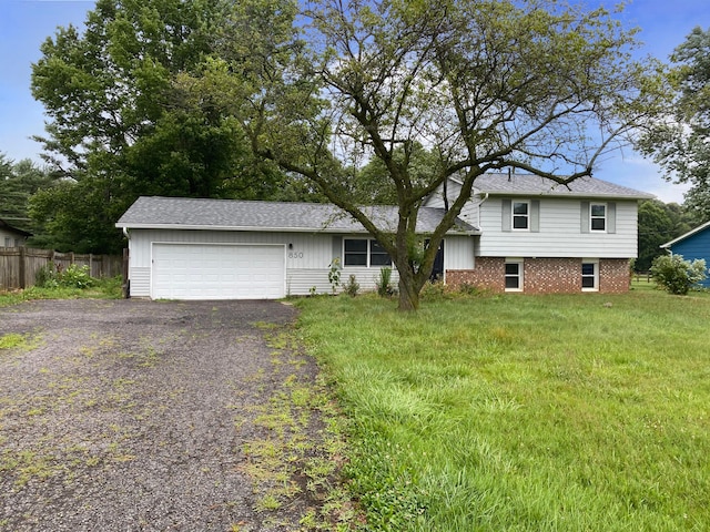 tri-level home featuring a front yard and a garage