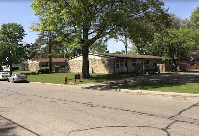 ranch-style home with a front lawn