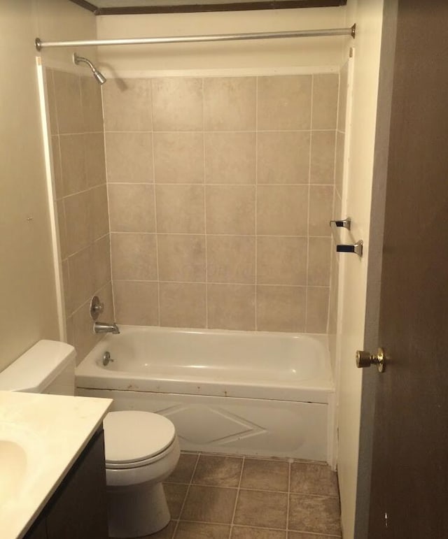 full bathroom with tile patterned floors, toilet, vanity, and tiled shower / bath