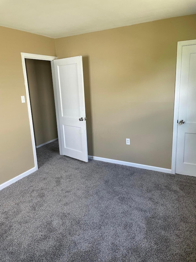 unfurnished bedroom with carpet floors and a closet