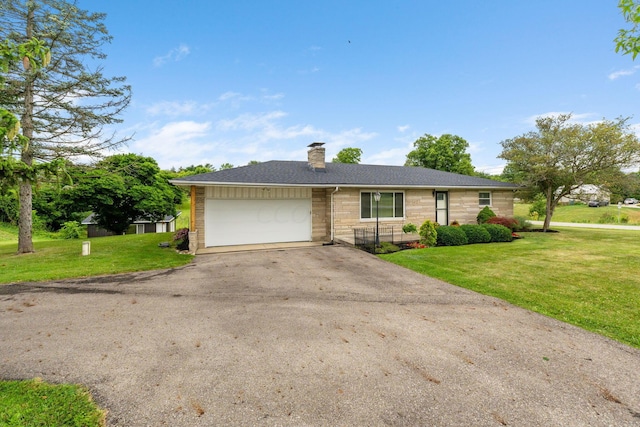 ranch-style home with a front lawn and a garage