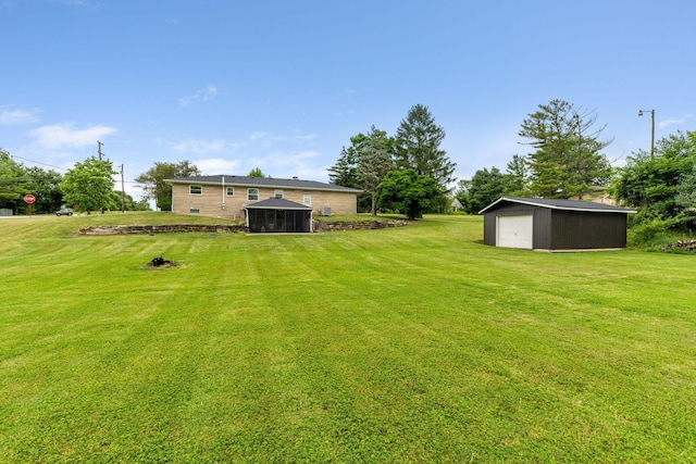 view of yard featuring an outbuilding and a garage