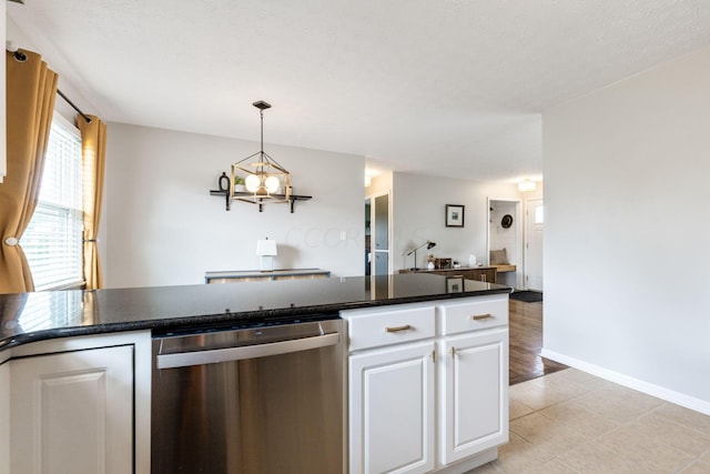 kitchen with dishwasher, white cabinets, light tile patterned floors, a textured ceiling, and a notable chandelier