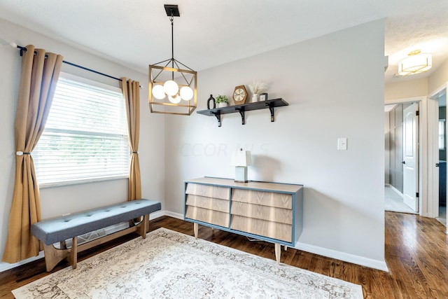 interior space with dark wood-type flooring and an inviting chandelier