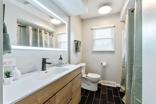 bathroom featuring vanity and toilet