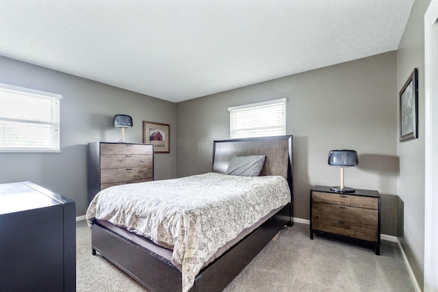 carpeted bedroom featuring a textured ceiling