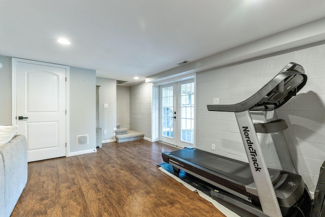 exercise area with dark hardwood / wood-style floors and french doors