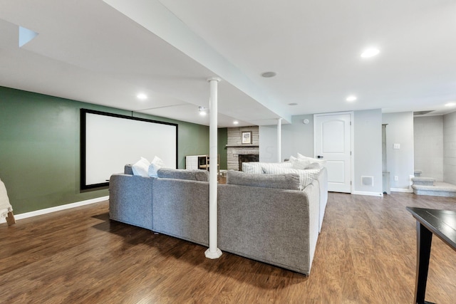 living room featuring hardwood / wood-style floors and a large fireplace