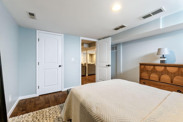 bedroom with dark hardwood / wood-style flooring