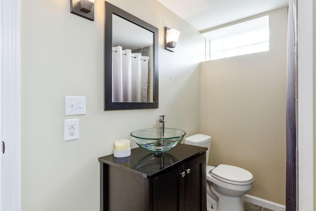 bathroom with tile patterned floors, vanity, and toilet