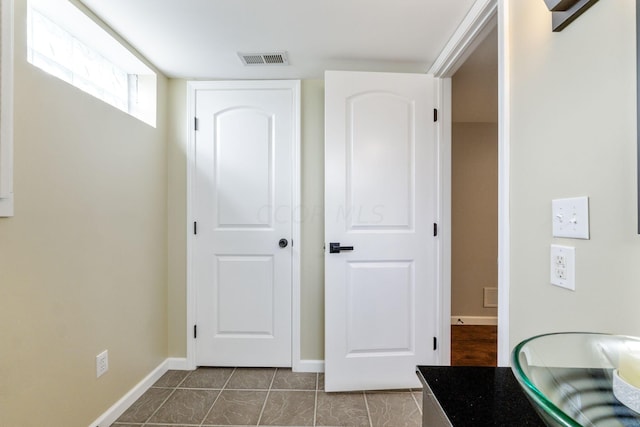 hall featuring tile patterned floors