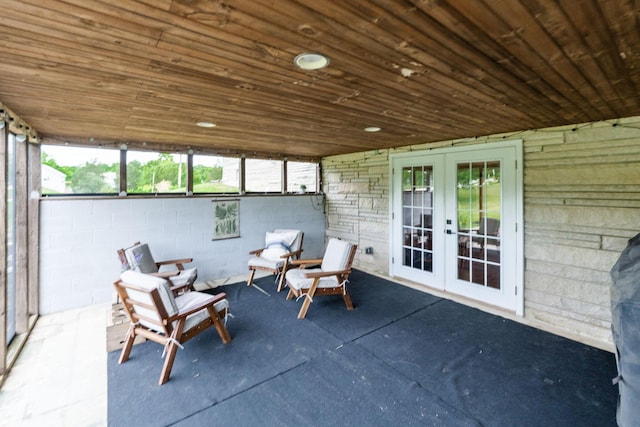 unfurnished sunroom featuring french doors, wood ceiling, and vaulted ceiling