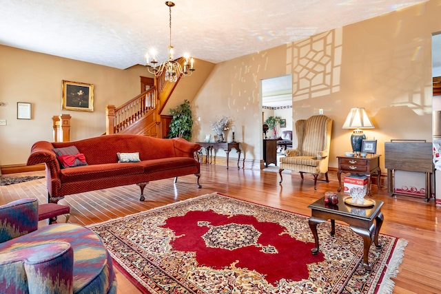 living room with hardwood / wood-style floors and a notable chandelier