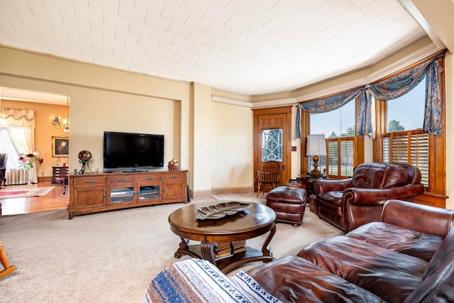 living room featuring carpet floors and an inviting chandelier