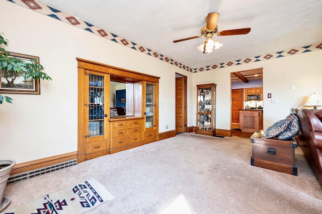 carpeted living room with a textured ceiling, a baseboard radiator, and ceiling fan